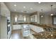 Spacious kitchen featuring white cabinetry and granite countertops at 28548 N 68Th Ave, Peoria, AZ 85383