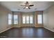 Bright living room with dark tile floors and window coverings at 28548 N 68Th Ave, Peoria, AZ 85383