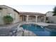 Inviting pool with a rock waterfall feature and patio at 28548 N 68Th Ave, Peoria, AZ 85383