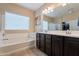 Bathroom with double sinks, shower, and bathtub at 2925 E Tonto Dr, Gilbert, AZ 85298