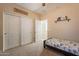 Spacious bedroom with twin bed, built-in shelving, and double door closet at 2925 E Tonto Dr, Gilbert, AZ 85298