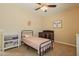 Bright bedroom featuring a twin bed, ceiling fan, and ample closet space at 2925 E Tonto Dr, Gilbert, AZ 85298