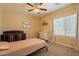 Charming bedroom with a twin bed, dresser, and ceiling fan at 2925 E Tonto Dr, Gilbert, AZ 85298