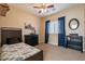 Bedroom with twin bed, dresser, ceiling fan, and window coverings at 2925 E Tonto Dr, Gilbert, AZ 85298