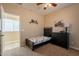 Well-lit bedroom with twin bed, dresser, and access to bathroom at 2925 E Tonto Dr, Gilbert, AZ 85298