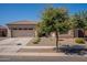 One-story home with tan exterior, two-car garage, and landscaped front yard at 2925 E Tonto Dr, Gilbert, AZ 85298