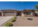 Tan colored house with a two-car garage and nicely landscaped yard at 2925 E Tonto Dr, Gilbert, AZ 85298