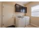 Bright laundry room, washer, dryer, and cabinets at 2925 E Tonto Dr, Gilbert, AZ 85298