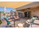 Relaxing patio with seating area, pool view, and shade structure at 2925 E Tonto Dr, Gilbert, AZ 85298