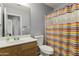 Clean bathroom with wood vanity and colorful shower curtain at 29875 N Sedona Pl, San Tan Valley, AZ 85143