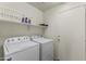 Laundry room with washer, dryer, and storage shelves at 29875 N Sedona Pl, San Tan Valley, AZ 85143