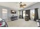 Bright living room with ceiling fan, large windows, and comfortable seating at 29875 N Sedona Pl, San Tan Valley, AZ 85143