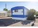 Blue and white mobile home with carport and landscaping at 345 S 58Th St # 27, Mesa, AZ 85206