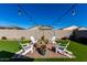 Relaxing backyard with firepit and seating area, perfect for outdoor gatherings at 35170 W La Paz St, Maricopa, AZ 85138