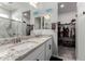 Double vanity bathroom with granite countertop and walk-in shower at 35170 W La Paz St, Maricopa, AZ 85138