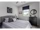 Secondary bedroom with a queen bed and dark dresser at 35170 W La Paz St, Maricopa, AZ 85138