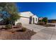 Single story home with a tan garage door and desert landscaping at 35170 W La Paz St, Maricopa, AZ 85138