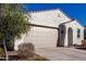 Single story home with tan garage door and desert landscaping at 35170 W La Paz St, Maricopa, AZ 85138