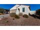 Single story home with a tan garage door and desert landscaping at 35170 W La Paz St, Maricopa, AZ 85138