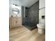 Modern bathroom showcasing a vanity with wood cabinet and tiled shower with glass door at 4032 N 11Th Ave, Phoenix, AZ 85013