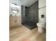 Modern bathroom showcasing a vanity with wood cabinet and tiled shower with glass door at 4032 N 11Th Ave, Phoenix, AZ 85013