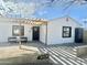 Charming single-story home with a modern pergola, black trim windows and number on the front at 4032 N 11Th Ave, Phoenix, AZ 85013