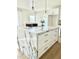 Spacious kitchen island featuring a white marble countertop, cabinets and gold handles at 4032 N 11Th Ave, Phoenix, AZ 85013