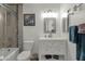 Clean bathroom, featuring a white vanity, shower/tub combo, and updated tile at 4048 W Sierra Vista Dr, Phoenix, AZ 85019