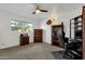 Home office in a bright bedroom with wood furniture and window views at 4048 W Sierra Vista Dr, Phoenix, AZ 85019