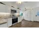 Modern kitchen with white cabinets and stainless steel appliances at 4048 W Sierra Vista Dr, Phoenix, AZ 85019