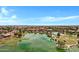 Aerial view of a community with a pond, pool, clubhouse, and walking trails for outdoor activities at 42085 W Morning Glory Way, Maricopa, AZ 85138