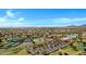 A panoramic aerial view showcasing the clubhouse, tennis courts, and landscaped grounds of the vibrant community at 42085 W Morning Glory Way, Maricopa, AZ 85138