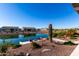 Relaxing backyard oasis with lake views, seating area, and desert landscaping at 42085 W Morning Glory Way, Maricopa, AZ 85138