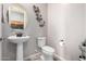 Elegant powder room with pedestal sink and modern fixtures at 42085 W Morning Glory Way, Maricopa, AZ 85138