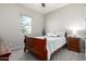 Bright bedroom featuring a wooden bed frame and ample natural light at 42085 W Morning Glory Way, Maricopa, AZ 85138