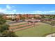 A view of the clubhouse, bocce ball and putting green areas within a gated community, perfect for outdoor recreation at 42085 W Morning Glory Way, Maricopa, AZ 85138