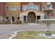 Up close perspective of an elegant entry with fountain, with partial views of the multi-colored building at 42085 W Morning Glory Way, Maricopa, AZ 85138