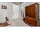 Entryway with wood flooring, white door, and wooden cabinet at 42085 W Morning Glory Way, Maricopa, AZ 85138