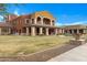 View of an elegant multi-story, multi-colored community building featuring beautiful grounds and architectural details at 42085 W Morning Glory Way, Maricopa, AZ 85138