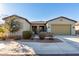 Single-story home with two-car garage and desert landscaping at 42085 W Morning Glory Way, Maricopa, AZ 85138