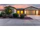 Charming home exterior featuring a gated entryway, two-car garage, and landscaped front yard at 42085 W Morning Glory Way, Maricopa, AZ 85138