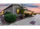 Exterior shot showing lush landscaping and a well-maintained sidewalk along the side of the home at 42085 W Morning Glory Way, Maricopa, AZ 85138
