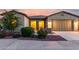 Landscaped yard showing the front of the home at sunset with a walkway, shrubs, and stone accents at 42085 W Morning Glory Way, Maricopa, AZ 85138
