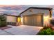 Beautiful home exterior with a two-car garage, and a landscaped yard at 42085 W Morning Glory Way, Maricopa, AZ 85138
