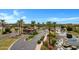 Scenic gated entrance with palm trees, lush landscaping, and a secure entry point to a vibrant community at 42085 W Morning Glory Way, Maricopa, AZ 85138