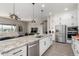 Modern kitchen, granite island, white cabinetry at 42085 W Morning Glory Way, Maricopa, AZ 85138