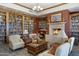 Inviting library featuring a cozy fireplace, beautiful bookshelves, and comfortable seating at 42085 W Morning Glory Way, Maricopa, AZ 85138