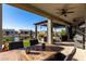 Outdoor patio with table and chairs, overlooking a pond at 42085 W Morning Glory Way, Maricopa, AZ 85138