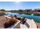 Enjoy lake views from this spacious patio with fire pit and seating at 42085 W Morning Glory Way, Maricopa, AZ 85138