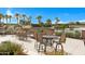 Stunning patio area with stylish outdoor seating, lush landscaping, and scenic water views at 42085 W Morning Glory Way, Maricopa, AZ 85138